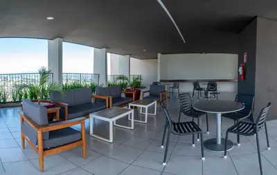 a restaurant with tables and chairs and a whiteboard at Condo 9, San Francisco Tower in San Salvador