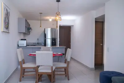 a kitchen and dining room with a table and chairs at Condo 9, San Francisco Tower in San Salvador