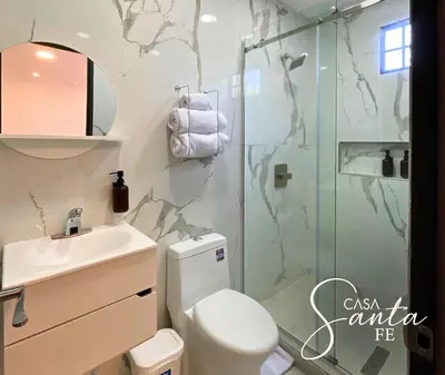 a bathroom with a shower and a toilet and a sink at Casa Santa Fe in San Salvador