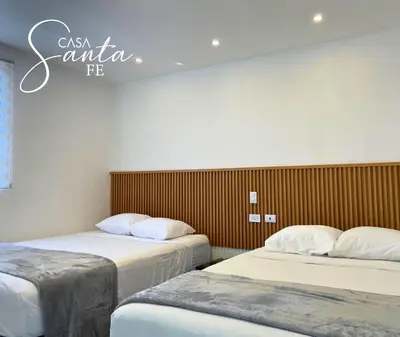 a room with two beds and a sign on the wall at Casa Santa Fe in San Salvador