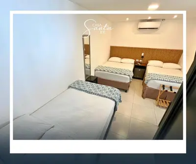 a hospital room with two beds and a table at Casa Santa Fe in San Salvador