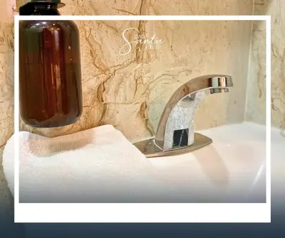 a bathroom sink with a soap dispenser on top of it at Casa Santa Fe in San Salvador