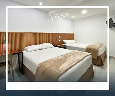 a hotel room with two beds and a desk at Casa Santa Fe in San Salvador
