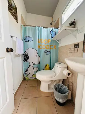 a bathroom with a toilet and a shower curtain at Toto's House, near Mall Las Ramblas in Santa Ana