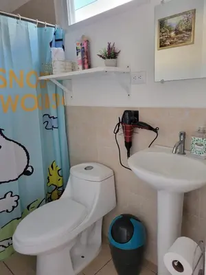 a bathroom with a toilet and a sink at Toto's House, near Mall Las Ramblas in Santa Ana