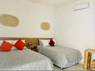 two beds sitting next to each other in a room at The Beach Break Hotel El Cocal in Playa San Blas