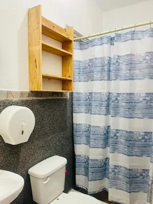 a bathroom with a toilet and a shower curtain at The Beach Break Hotel El Cocal in Playa San Blas