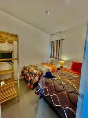 a bedroom with two beds and a ladder in it at Casa Ruta Termal - Ahuachapan in Ahuachapán