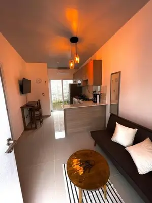a living room with a couch and a table at Casa Ruta Termal - Ahuachapan in Ahuachapán