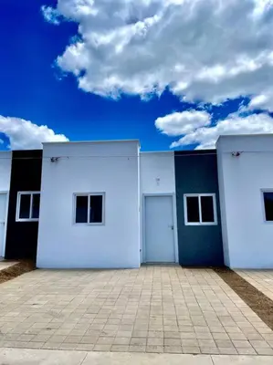 a white building with two doors and a sky at Casa Ruta Termal - Ahuachapan in Ahuachapán