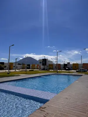 a swimming pool in a parking lot with mountains in the background at Tu Hogar Encantado Casa Entera con dos Habitaciones in San Miguel
