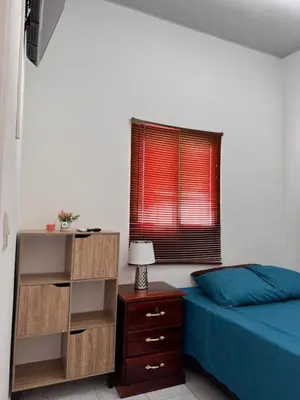 a bedroom with a bed and a dresser and a window at Tu Hogar Encantado Casa Entera con dos Habitaciones in San Miguel