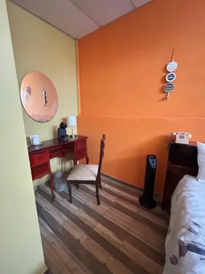 a bedroom with a desk and a bed and a desk at 1961 Los Naranjos Hostal in Los Naranjos