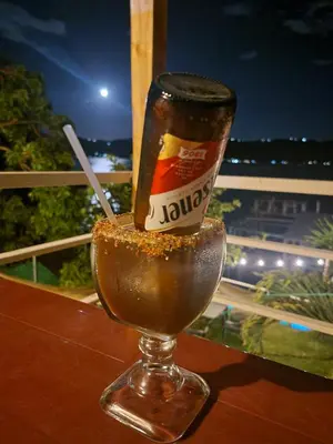 a drink in a glass on top of a table at Restaurante y Hostal Romayor in Hacienda Santa Rosa