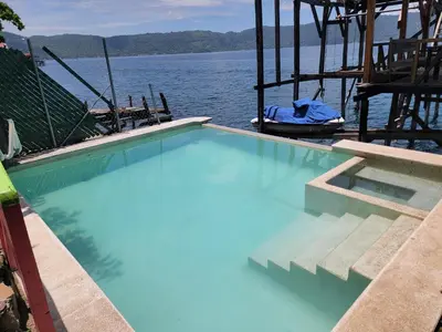 a swimming pool in the middle of a body of water at Restaurante y Hostal Romayor in Hacienda Santa Rosa