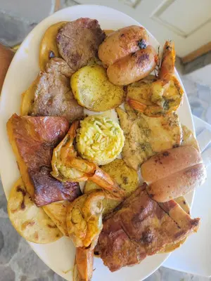 a plate of food with shrimp and other foods at Restaurante y Hostal Romayor in Hacienda Santa Rosa
