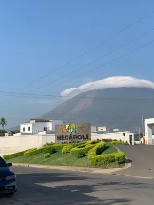 a sign for a mexican restaurant with a mountain in the background at La Casita de Vacaciones in San Miguel