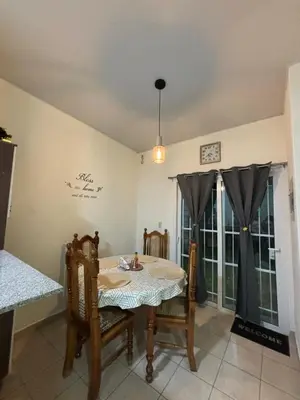 a dining room with a table and chairs and a window at La Casita de Vacaciones in San Miguel
