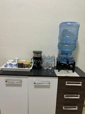 a counter top with a blender and glasses on it at La Casita de Vacaciones in San Miguel