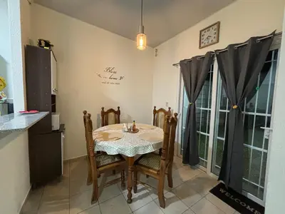a kitchen with a table and chairs in a room at La Casita de Vacaciones in San Miguel