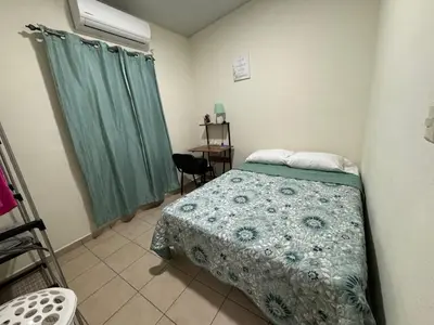 a small bedroom with a bed and a chair at La Casita de Vacaciones in San Miguel