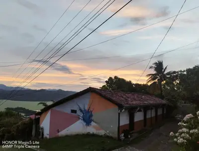 a house with a painting on the side of it at CASA LICHIs in Suchitoto