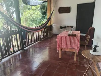a room with a table and a balcony at CASA LICHIs in Suchitoto