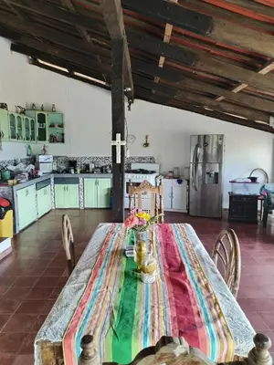 a kitchen with a long table with a cross on it at CASA LICHIs in Suchitoto