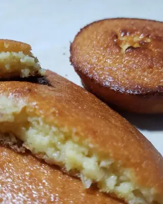a close up of three donuts with sugar on them at CASA LICHIs in Suchitoto