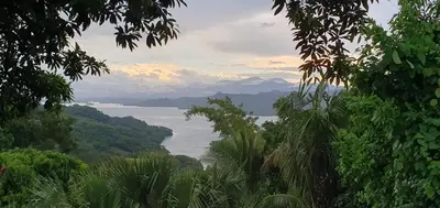a view of a body of water with mountains and trees at CASA LICHIs in Suchitoto
