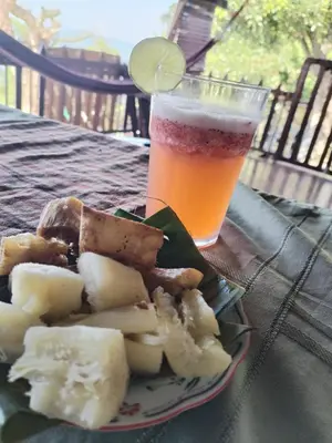 a plate of food and a glass of beer at CASA LICHIs in Suchitoto