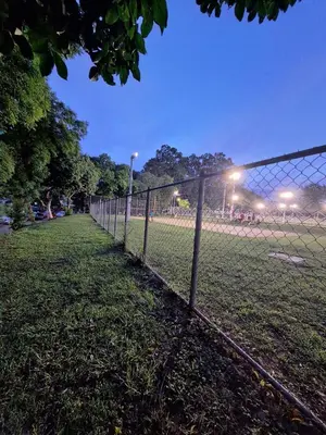 a chain link fence in a field at night at Casa de Limón 01 in Santa Ana