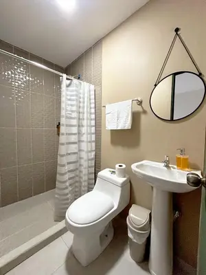 a bathroom with a toilet and a sink and a shower at Hotel Rimani in San Salvador