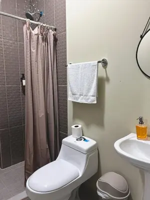 a bathroom with a toilet and a sink and a shower at Hotel Rimani in San Salvador