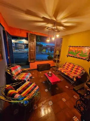 a living room with two chairs and a table at Santa Fe in Juayúa