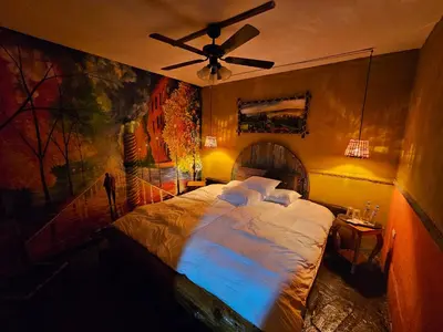 a bedroom with a large bed with a ceiling fan at Santa Fe in Juayúa