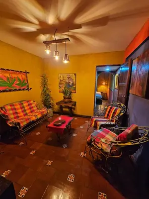 a living room with a couch and chairs and a table at Santa Fe in Juayúa