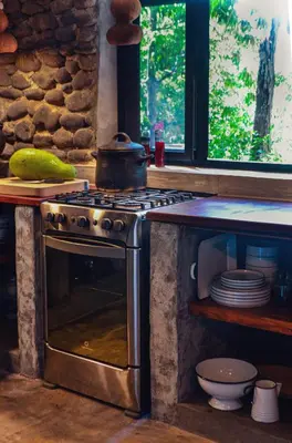 a kitchen with a stove with a pot on top of it at Unique Tiny House-Best Beach in El Zonte in El Zonte