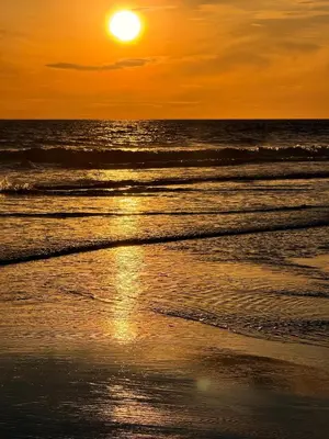 a sunset on the beach with the sun setting at Unique Tiny House-Best Beach in El Zonte in El Zonte