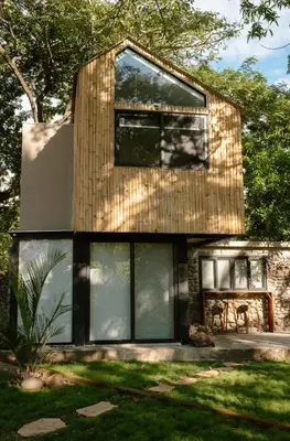 a house with large windows and a table in a yard at Unique Tiny House-Best Beach in El Zonte in El Zonte