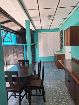a kitchen with a table and chairs in a room at Hostal Primaveras nest habitación 3 in Santa Ana