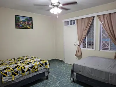 a bedroom with a bed and a ceiling fan at Hostal Primaveras nest habitación 3 in Santa Ana