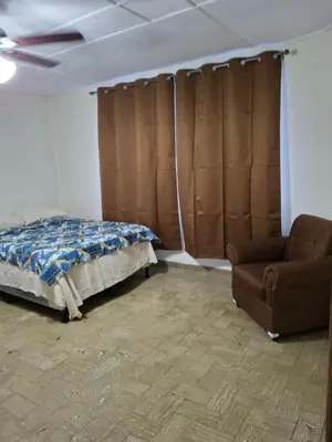 a bedroom with a bed and a couch and a chair at Hostal Primaveras nest habitación 3 in Santa Ana