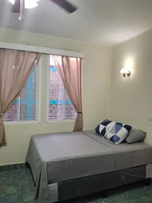 a bedroom with a bed and two windows at Hostal Primaveras nest habitación 3 in Santa Ana