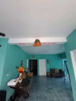 a living room with blue walls and a white ceiling at Hostal Primaveras nest habitación 3 in Santa Ana