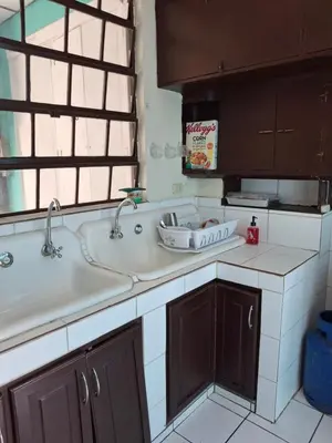 a kitchen counter with a sink and a window at Hostal Primaveras nest habitación 3 in Santa Ana