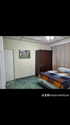 a bedroom with a bed and a painting on the wall at Hostal primaveras nest in Santa Ana