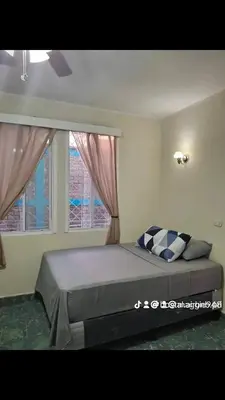 a bedroom with a large bed with two windows at Hostal primaveras nest in Santa Ana