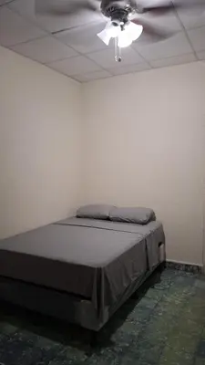 a bed in a room with a ceiling at Hostal primaveras nest in Santa Ana