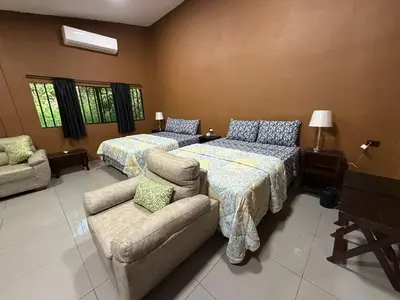 a living room with two beds and a couch at El Mangal 2 B&B in Suchitoto